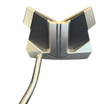 Close-up of a golf putter head with gold and black design on a white background