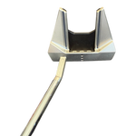 Golf putter head with gold and silver design on a white background